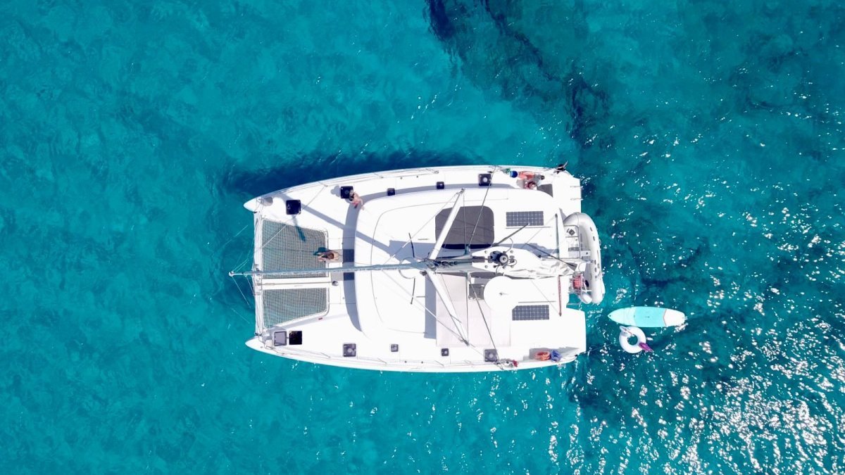 Aerial view of a Lagoon 42 catamaran yacht charter from La Cruz anchored in turquoise water in Banderas Bay