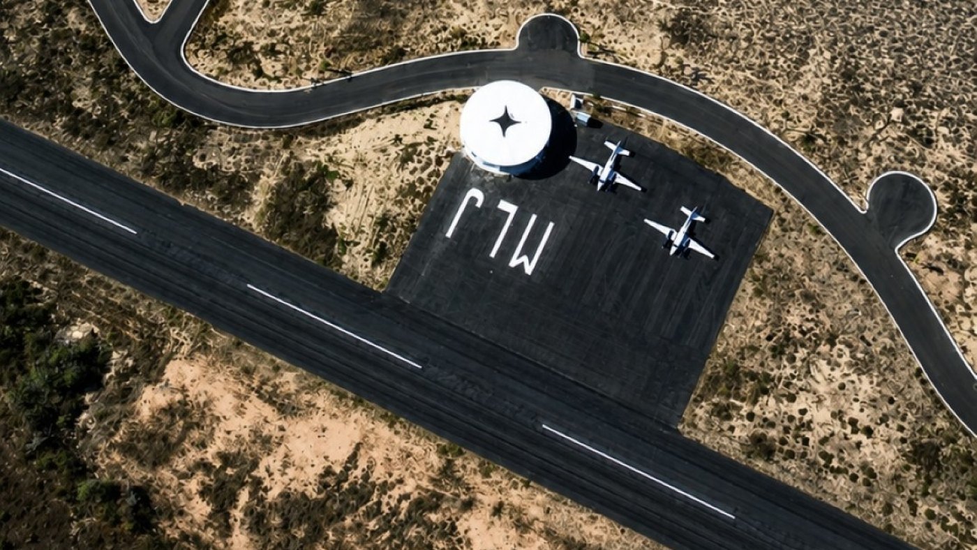 Circular terminal and apron at the Mayto airport with light aircraft parked and MJL painted on the asphalt