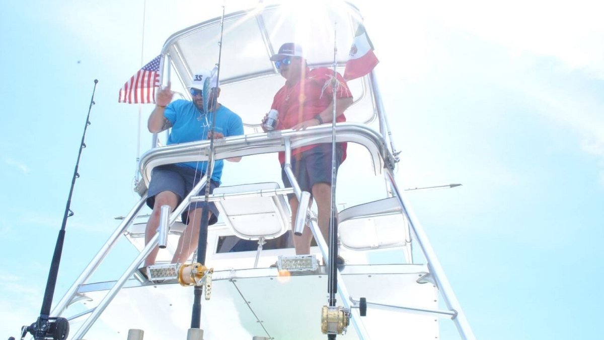 Captain and mate up in the tuna tower spotting fish on a sport fishing charter in Nuevo Vallarta